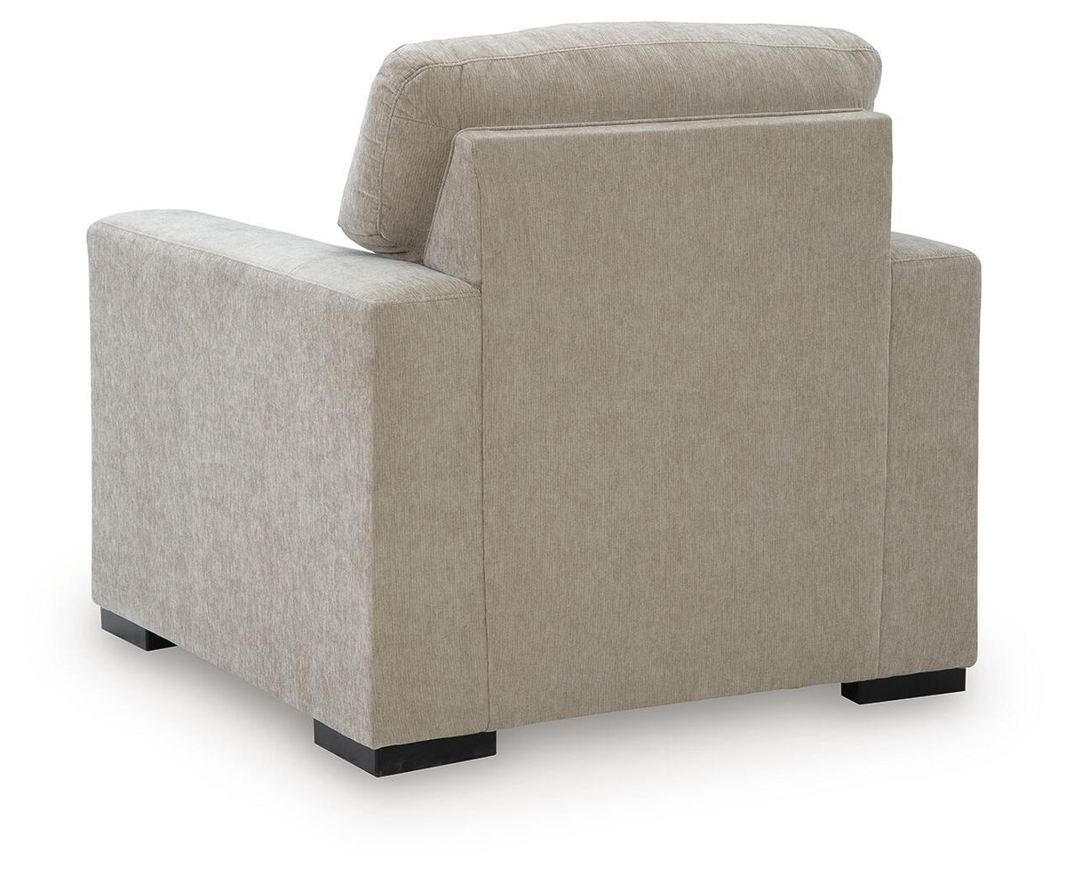Light brown fabric armchair viewed from front-side angle with tall back and padded seat.