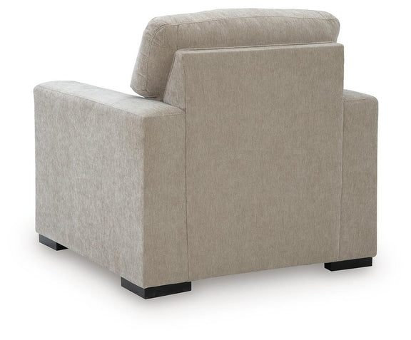 Light brown fabric armchair viewed from front-side angle with tall back and padded seat.