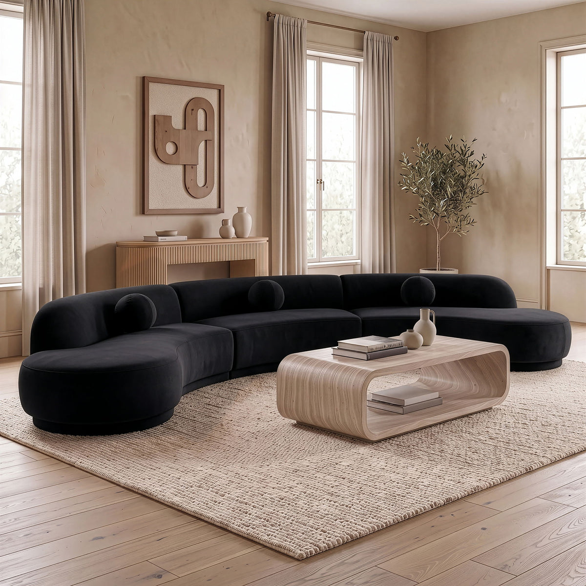 Charcoal velvet sectional with rounded chaise, multiple bolstered seats, and deep cushions