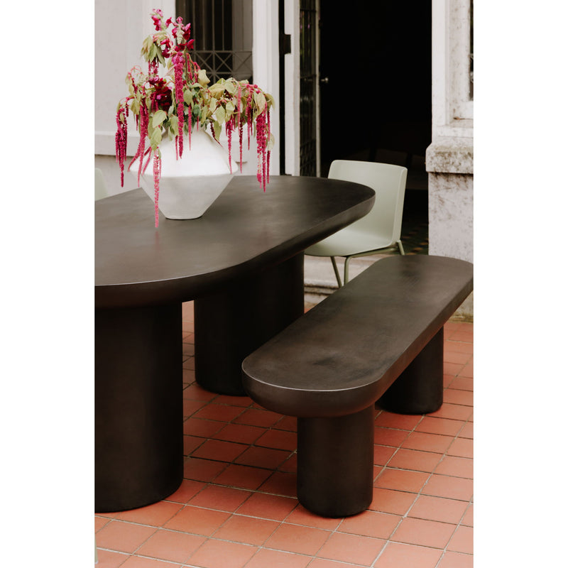 Black concrete bench seat with rounded edges and pedestal base supports