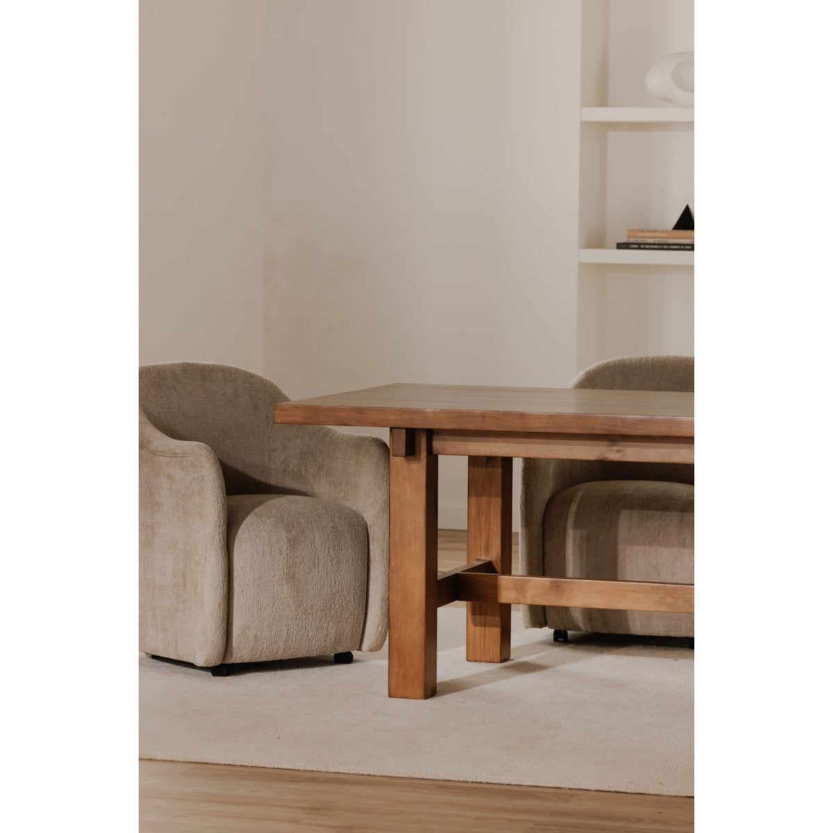 Beige fabric rolling dining chair with wide seat, low back, and casters