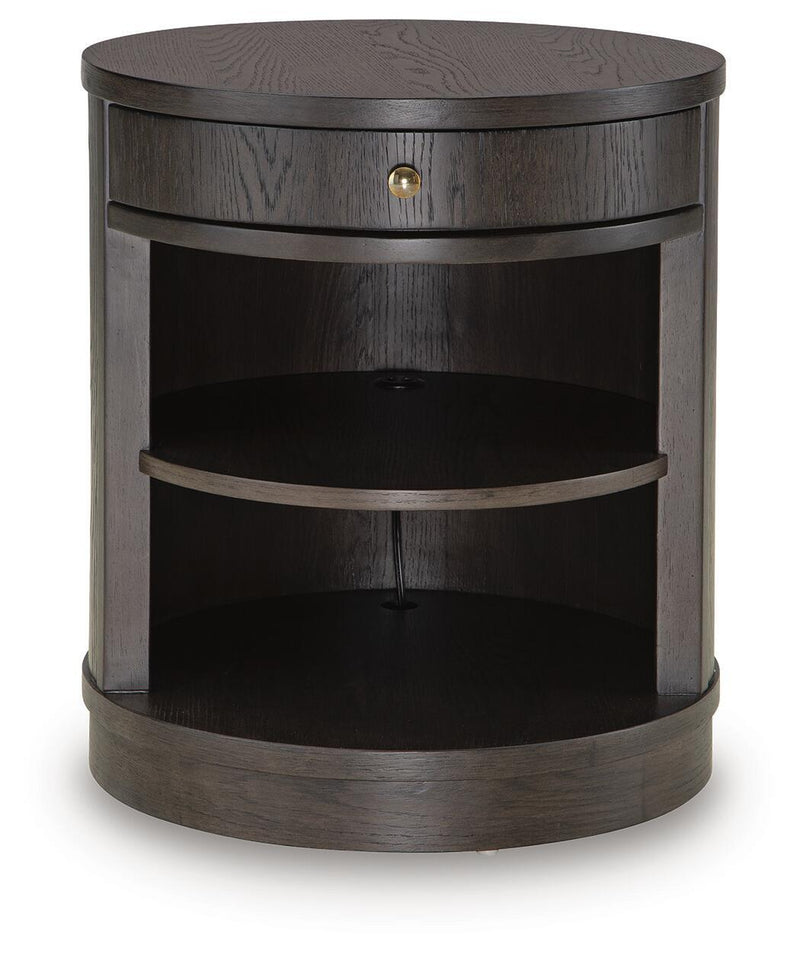 Dark brown round accent table with two open shelves and single drawer with brass knob