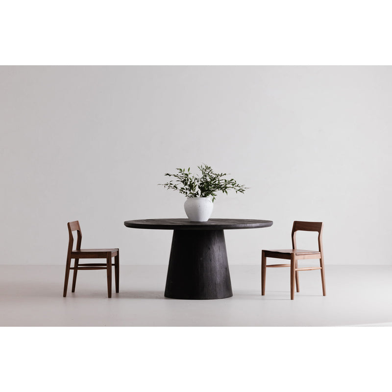 Cember round dining table with pedestal base and two wood dining chairs