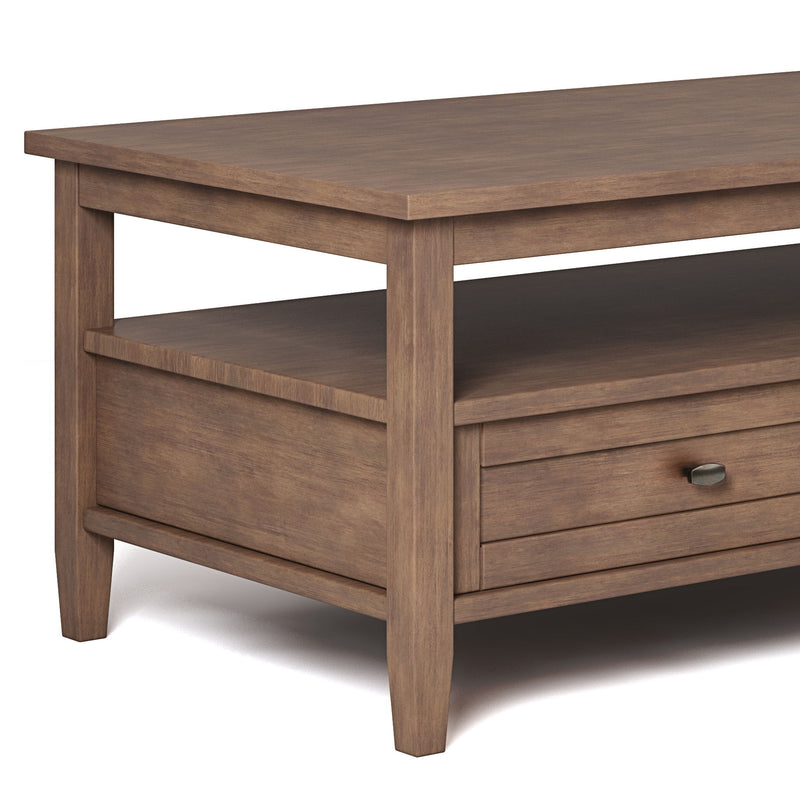 Coffee table detail showing the wood grain, open shelf, and drawer front