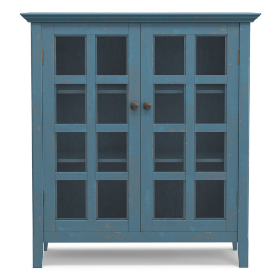 Medium storage cabinet with two glass doors in blue, silver knobs, and grid-style shelves.