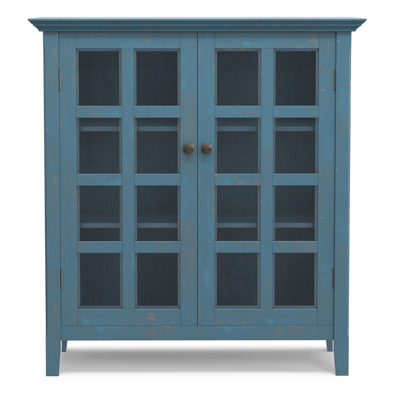 Medium storage cabinet with two glass doors in blue, silver knobs, and grid-style shelves.