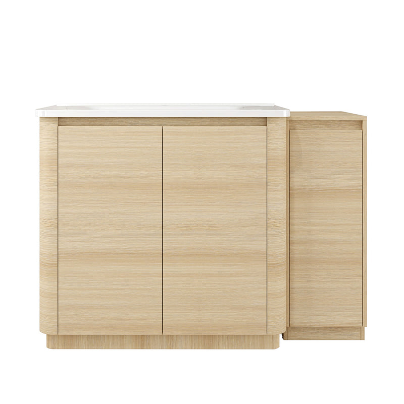 Freestanding bathroom vanity with white sink, light wood cabinet, and two closed doors