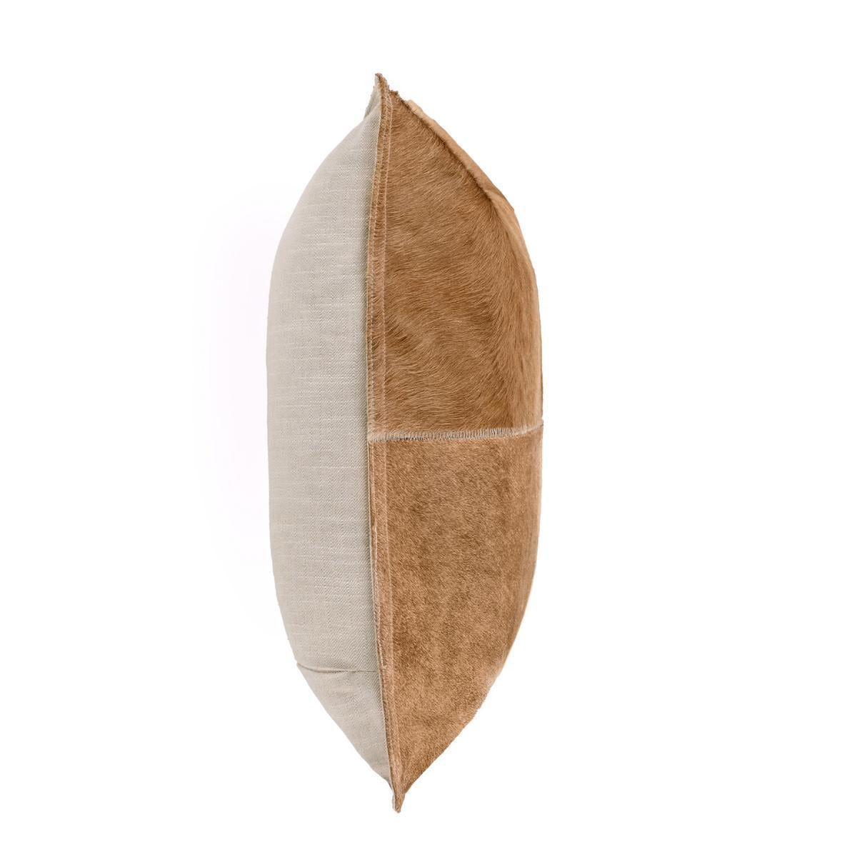 Tan hide pillow, side view with stitched quadrants and contrast fur panels