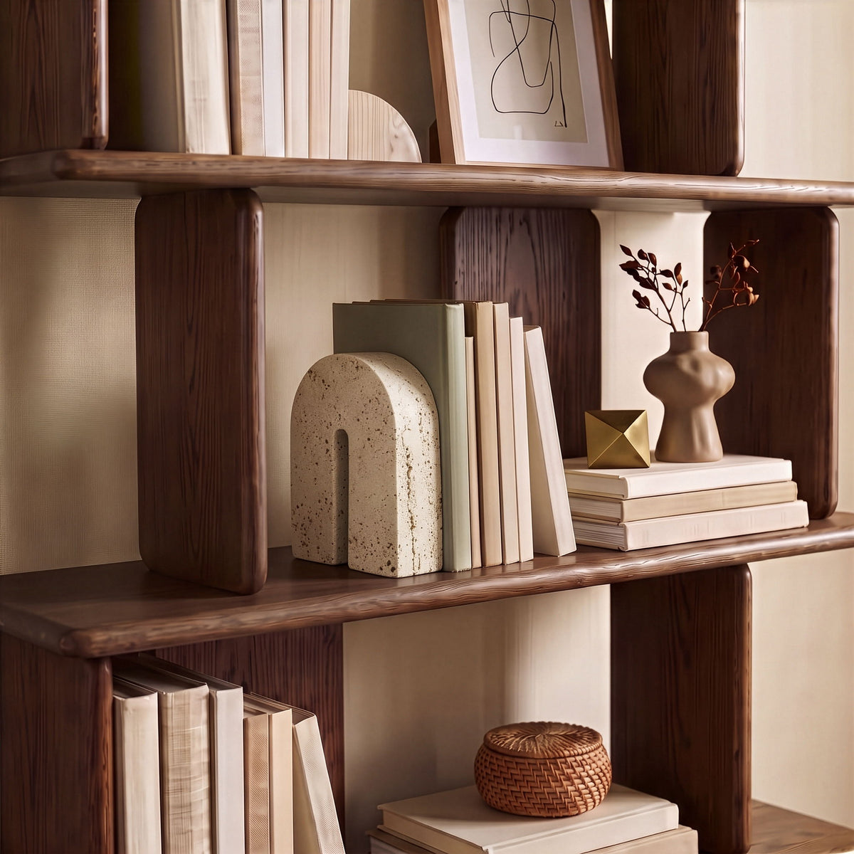Beige travertine bookend on a shelf, arched front with vertical cutout