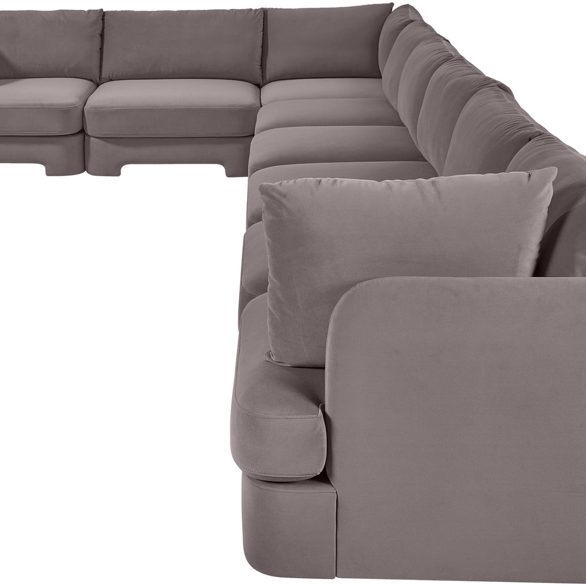 Gray L-shaped velvet sectional sofa with plush back pillows and wide chaise lounge