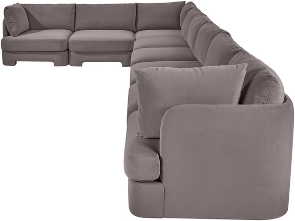 Gray L-shaped velvet sectional sofa with plush back pillows and wide chaise lounge