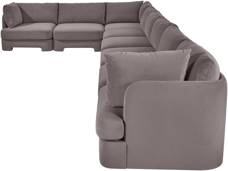Gray L-shaped velvet sectional sofa with plush back pillows and wide chaise lounge