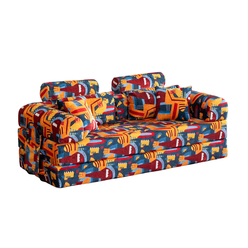 Convertible sofa bed with colorful city-pattern upholstery, padded armrests and cushions
