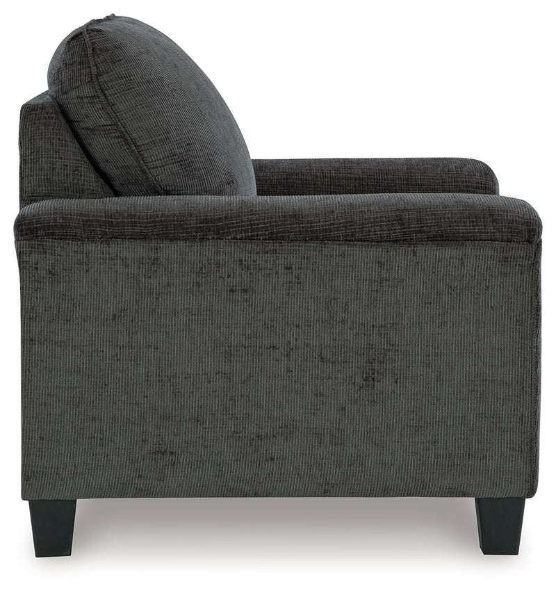 Upholstered armchair in dark gray textured fabric, rounded headrest and arms