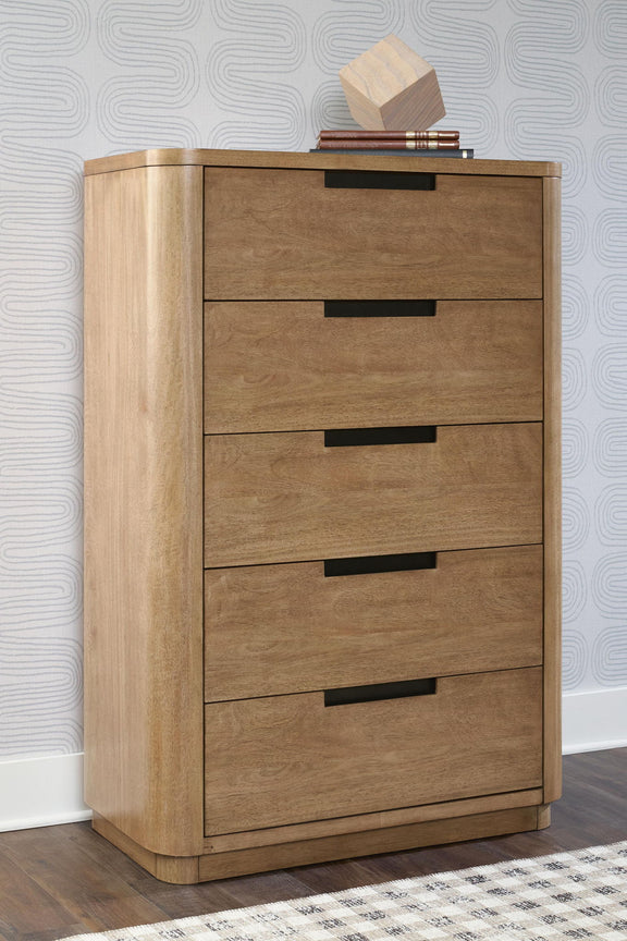 Light brown five-drawer chest, angled view, top shelf with stacked books