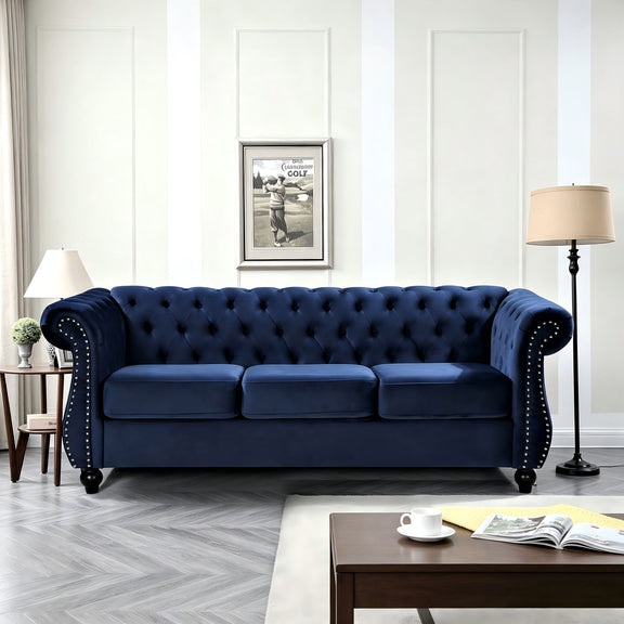 Blue three-seat button-tufted sofa with rolled arms and nail-trimmed edges