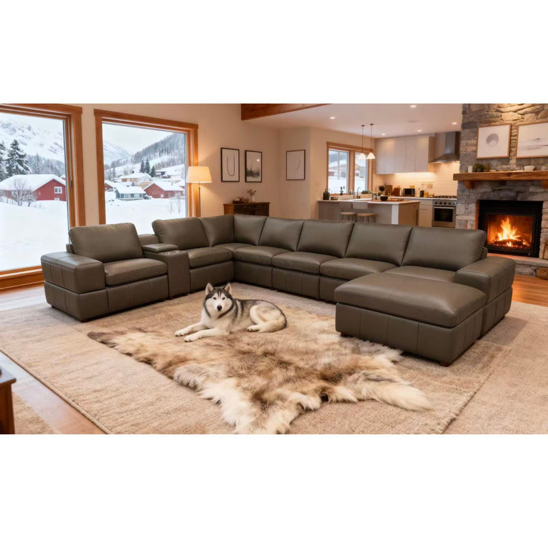 Dark green modular sectional sofa with large square arms and extended chaise ottoman