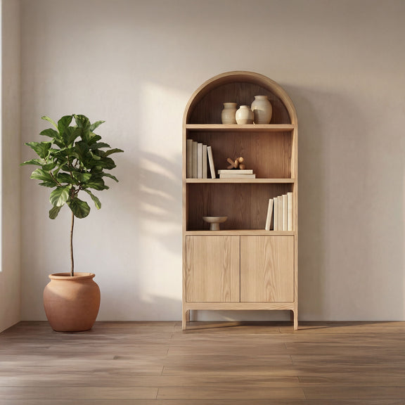 Natural wood display cabinet with arched top and open shelves holding books and decor