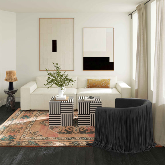 Black swivel chair with long fringe skirt and rounded back