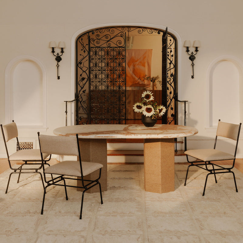 Pair of beige dining chairs with upholstered backs and black metal frames