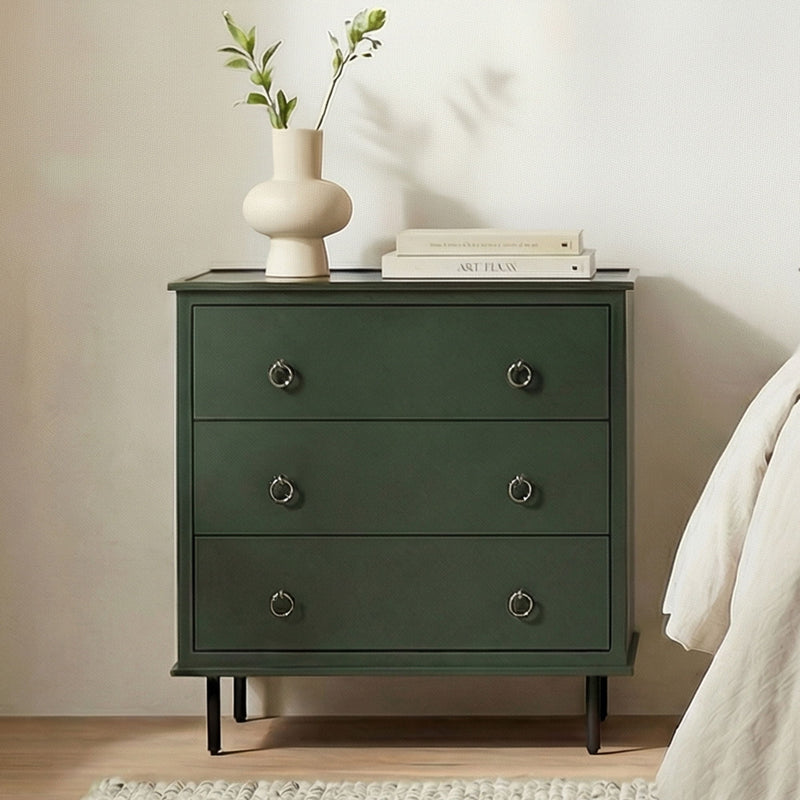 Deep green nightstand with three drawers, round metal handles, and tapered legs
