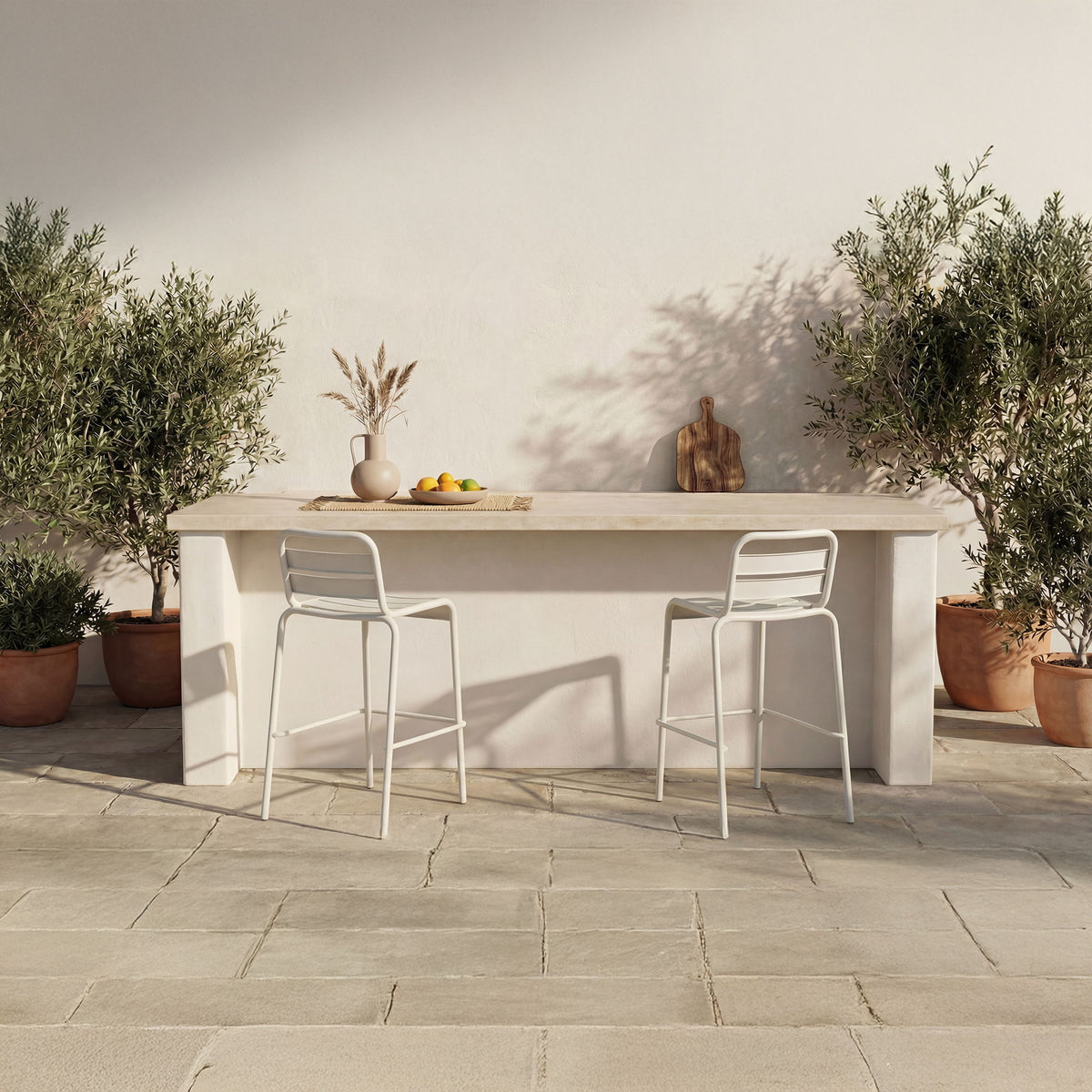 Two white outdoor bar stools with slatted backs, armless design on patio.