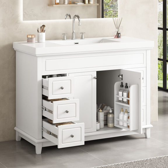 White bathroom vanity with open drawers and double doors, storage shelves under sink