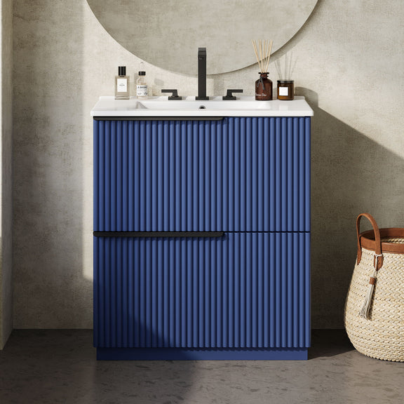 Blue fluted freestanding bathroom vanity with ceramic sink, two doors, and faucet