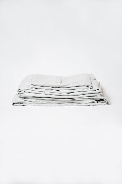 Gray microfiber and bamboo sheet set, folded stack with stitched edges