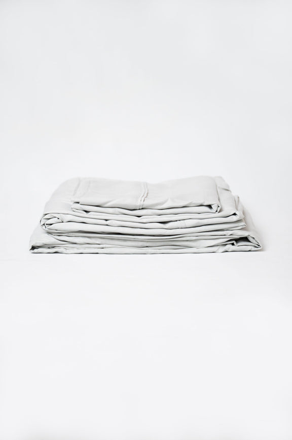Gray microfiber and bamboo sheet set, folded stack with stitched edges