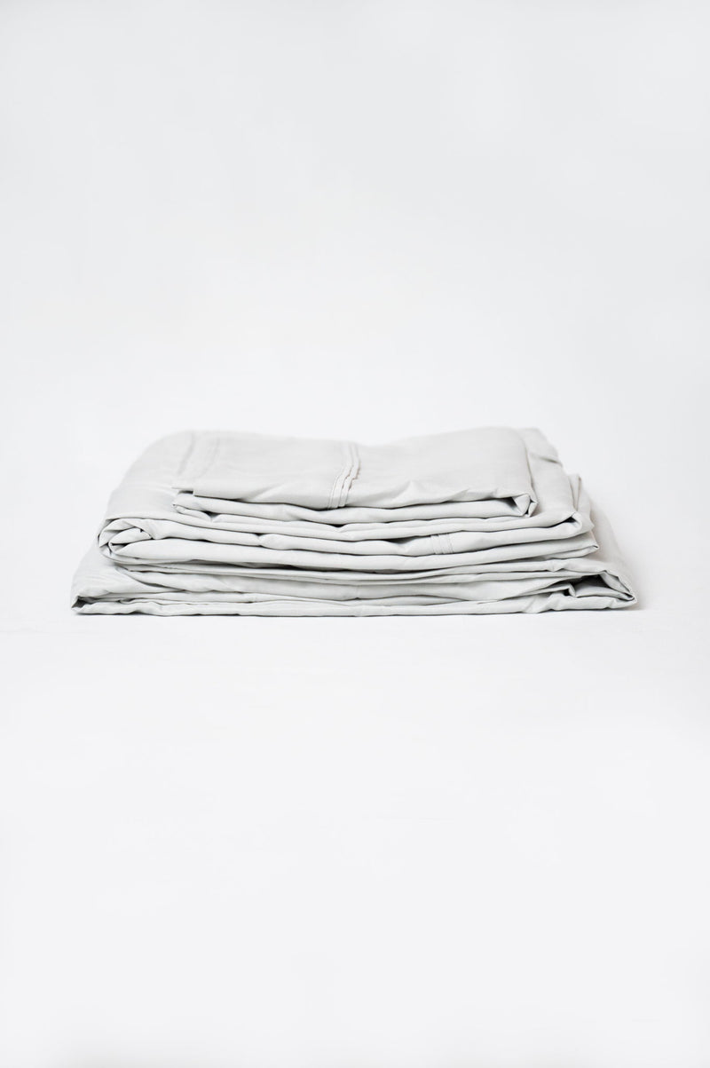 Gray microfiber and bamboo sheet set, folded stack with stitched edges
