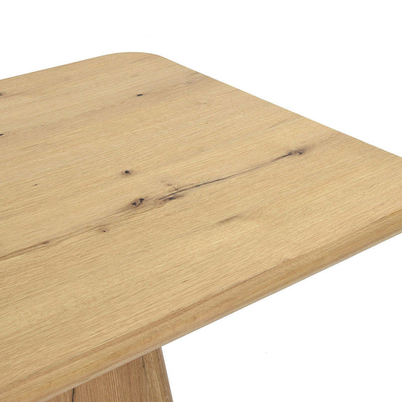 Close-up of light brown wood tabletop with visible grain and natural knots