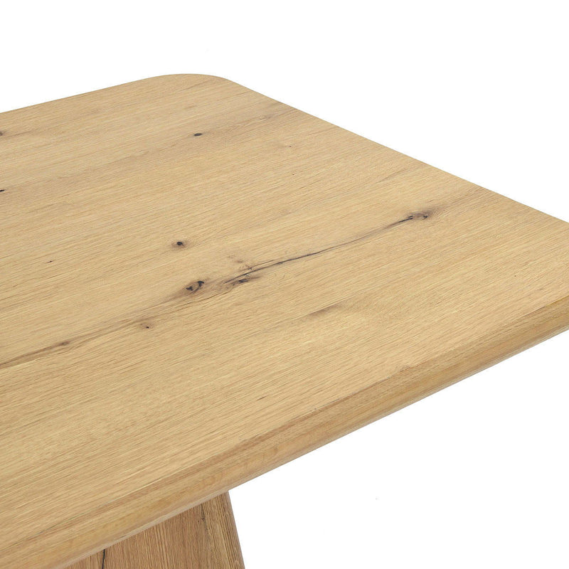 Close-up of light brown wood tabletop with visible grain and natural knots
