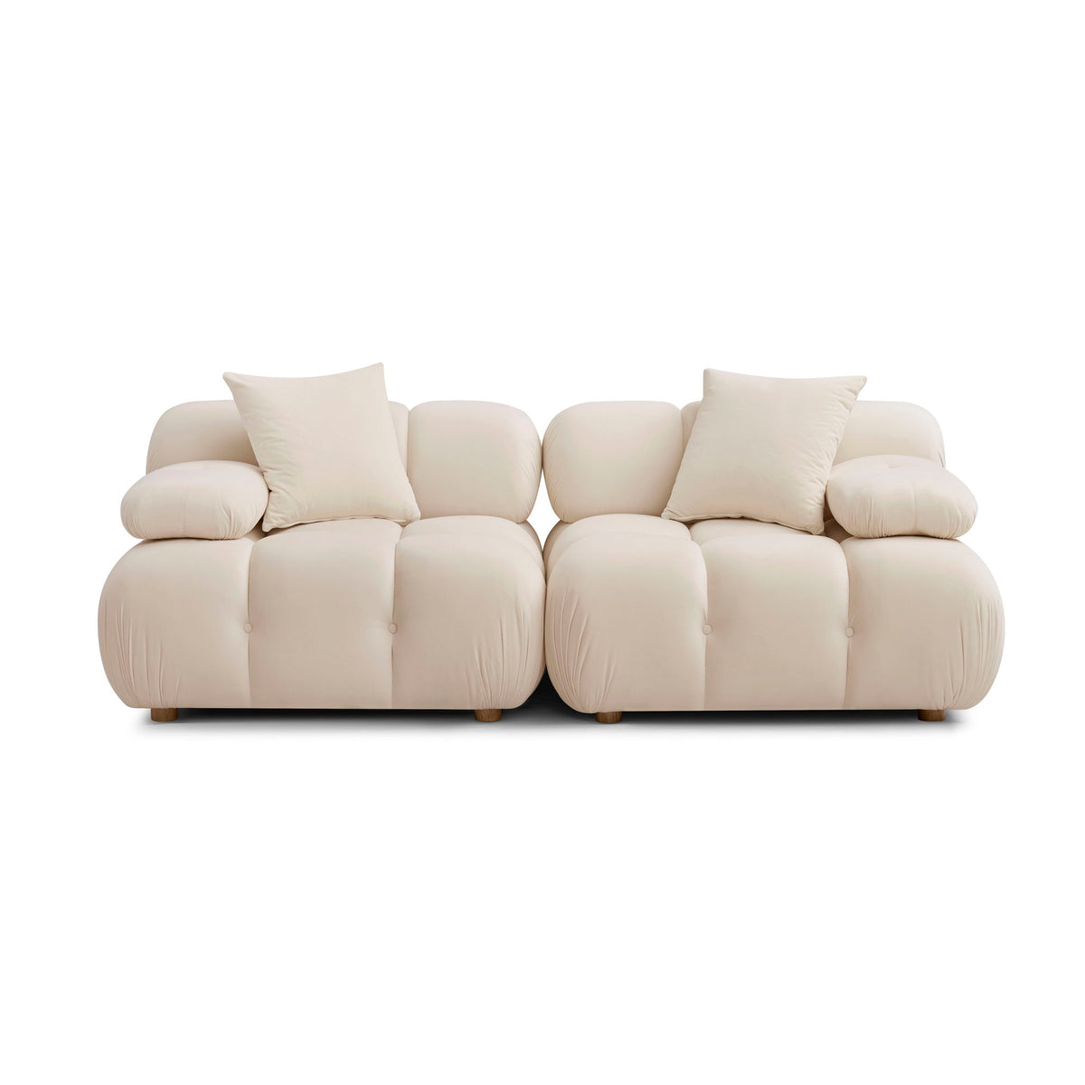 Modular loveseat sofa in cream upholstery with rounded arms and tufted seat sections