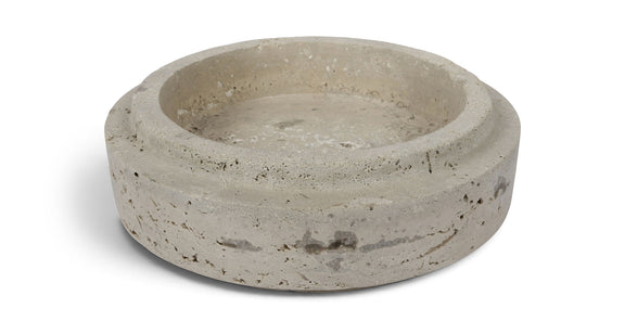 Light gray travertine bowl with shallow round basin and natural speckling