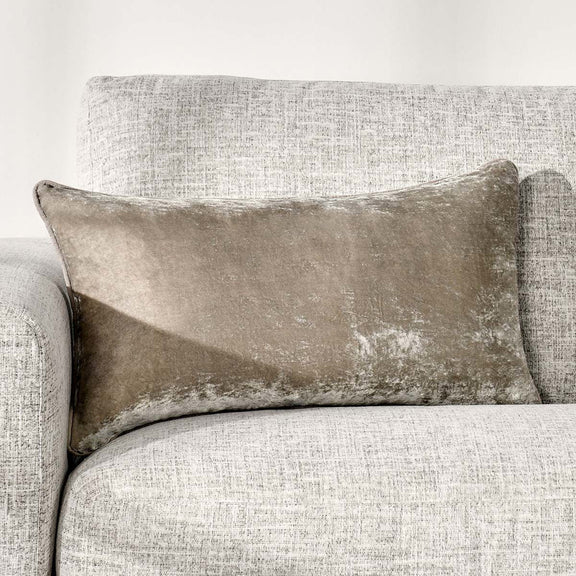 Taupe natural-toned lumbar pillow with distressed whitewashed pattern and piped edges