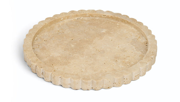 Beige travertine tray with scalloped rim, round shallow surface.