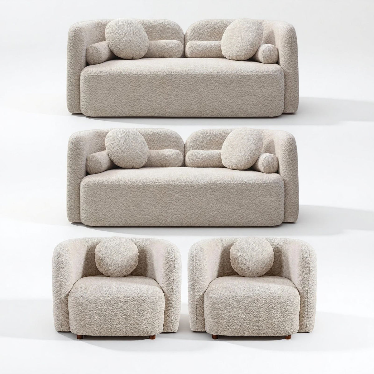 Beige upholstered sofa, loveseat, and two armchairs with round accent cushions