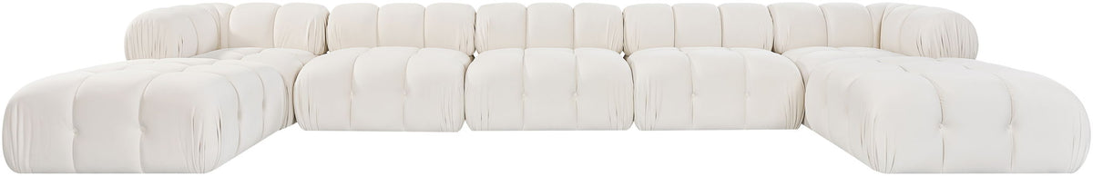 White modular sectional sofa with tufted cushions and matching rounded ottoman sections