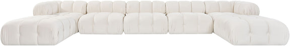 White modular sectional sofa with tufted cushions and matching rounded ottoman sections