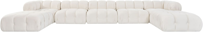 White modular sectional sofa with tufted cushions and matching rounded ottoman sections