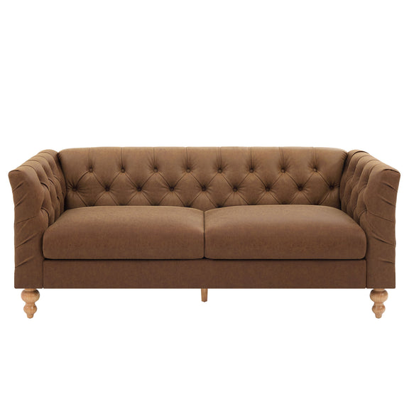 Light brown chesterfield-style sofa with tufted back, flared arms, and wooden legs
