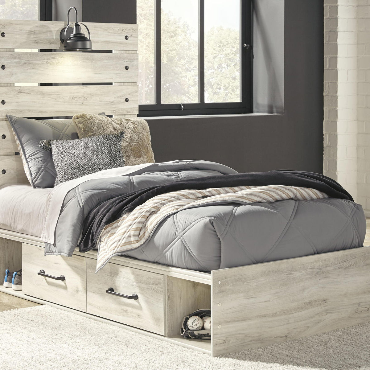 Cambeck panel bed with light wood frame, two front drawers, and upholstered bed linens