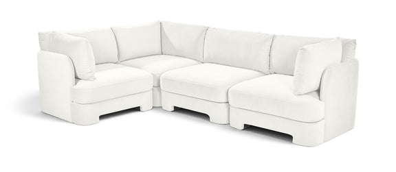 White velvet sectional sofa with upholstered arms, chaise corner, and matching cushions