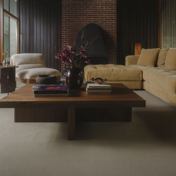 Walnut brown coffee table with rectangular top, viewed at a slight side angle.