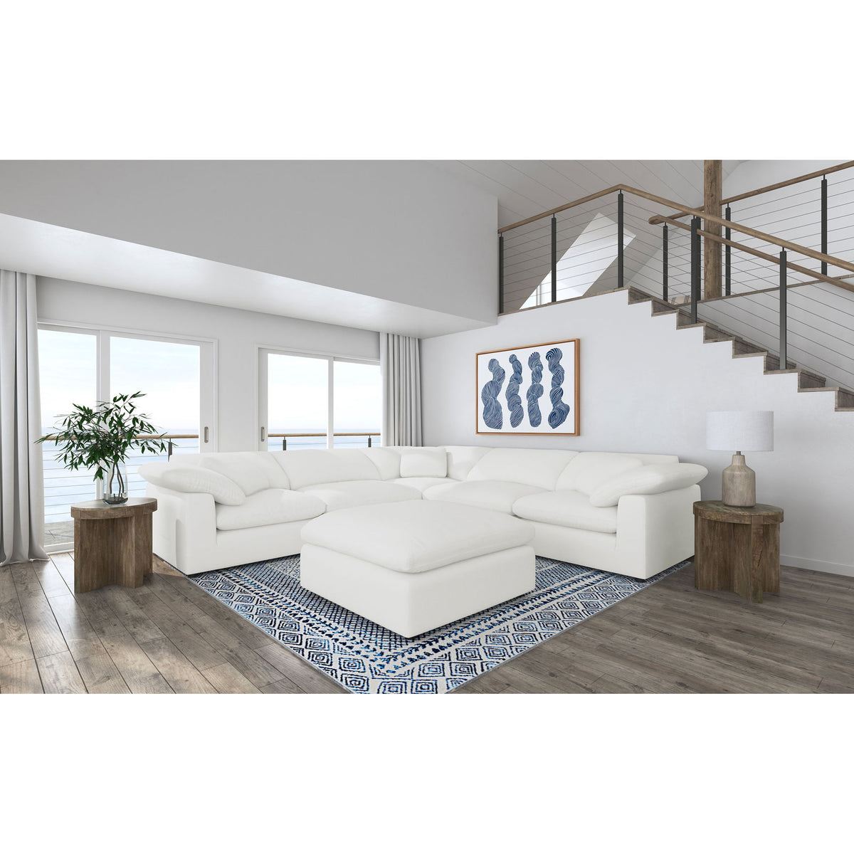 White modular sectional sofa with ottoman chaise, curved arms, and plush cushions