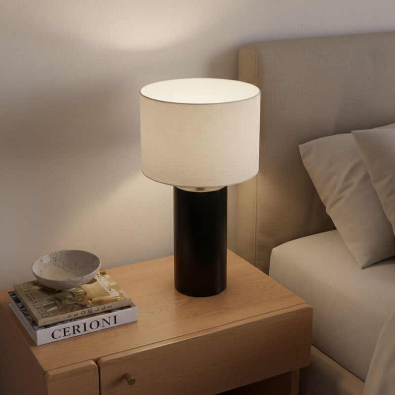 White drum shade table lamp with matte black cylindrical block base