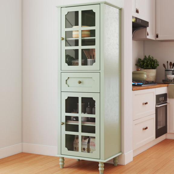 Pale green curio cabinet with glass grid doors and center drawer, shown stocked in a kitchen