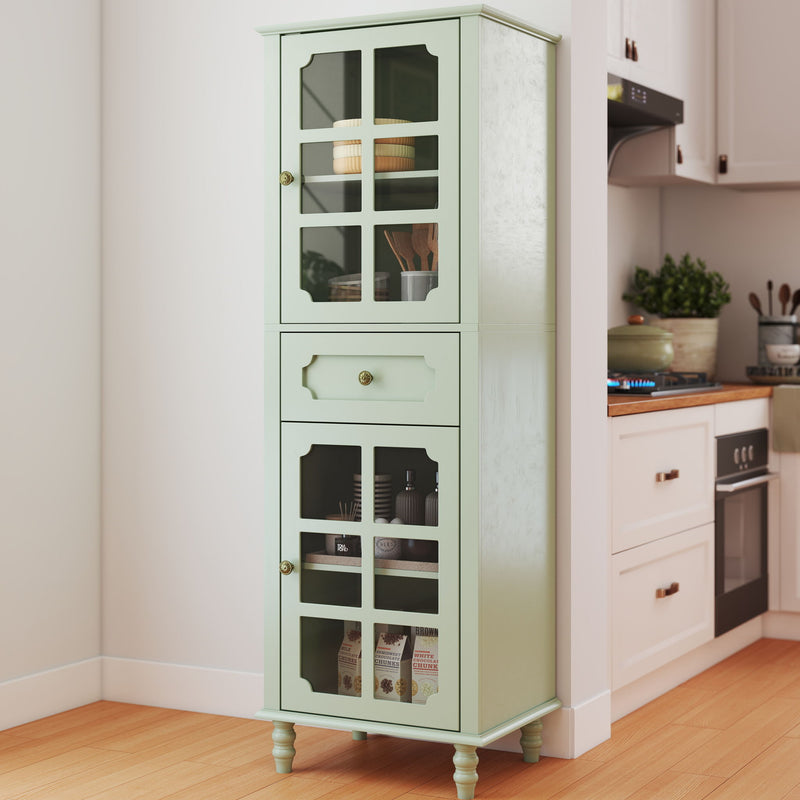 Pale green curio cabinet with glass grid doors and center drawer, shown stocked in a kitchen