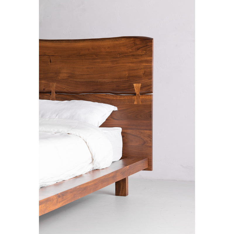 King platform bed with light brown wood frame and side rail, white pillows and duvet